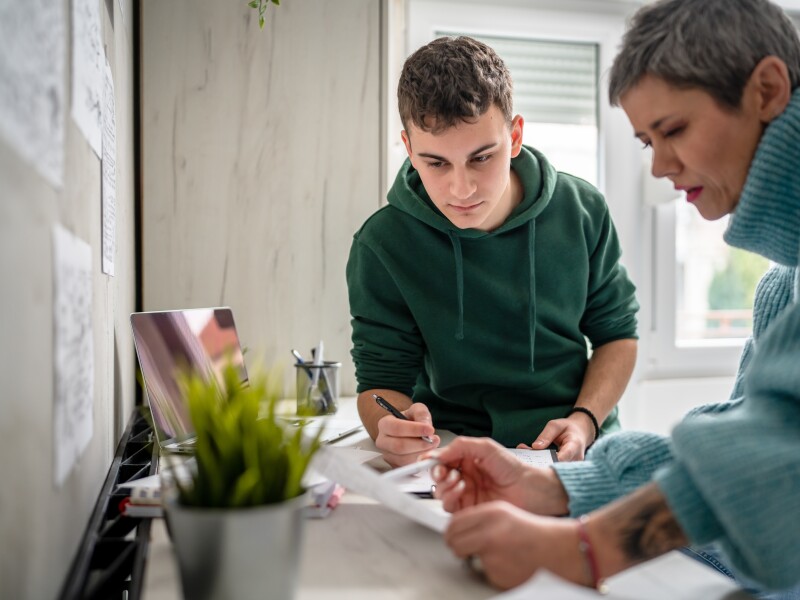 Mom and son reviewing paperwork