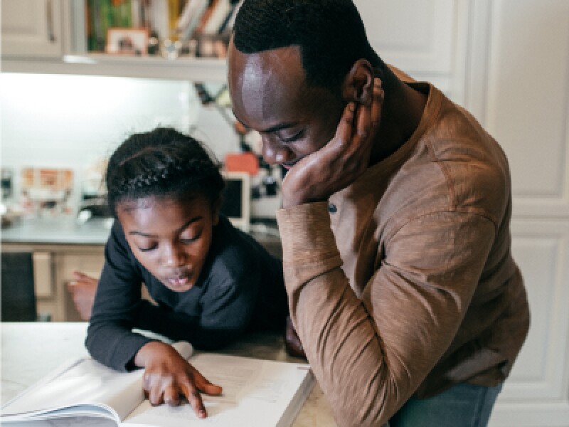 Dad helping daughter with homework