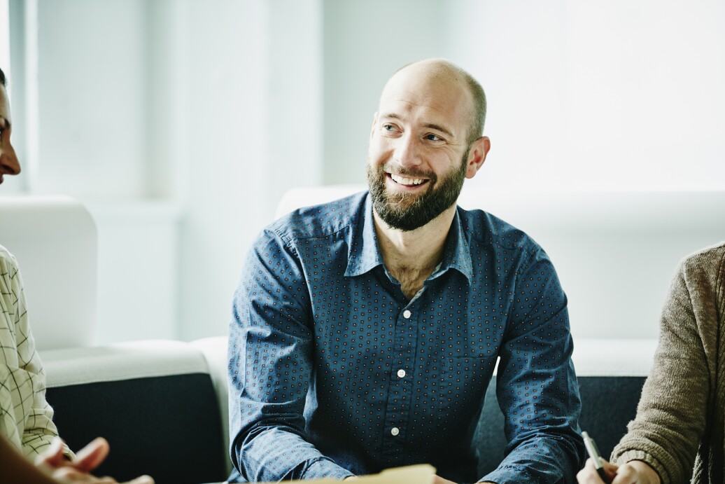 Smiling businessman in discussion with colleagues