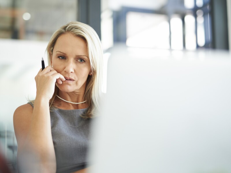 A woman sits at a computer.