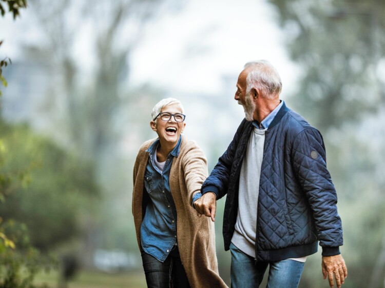Playful senior couple having fun in the park.