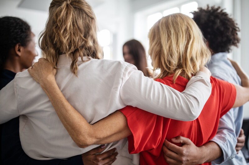 team of people huddling together