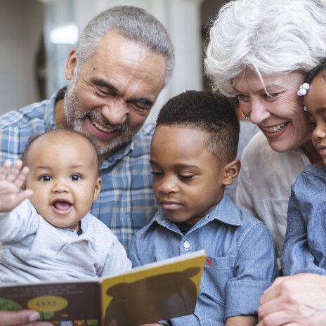 3 children enjoying story time with Grandma and Grandpa