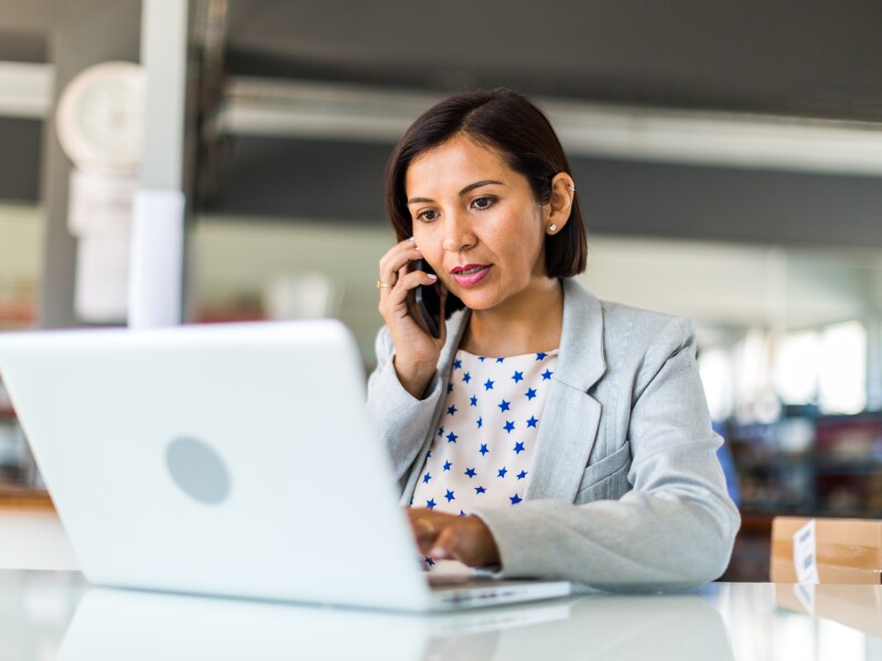 Woman on mobile and laptop