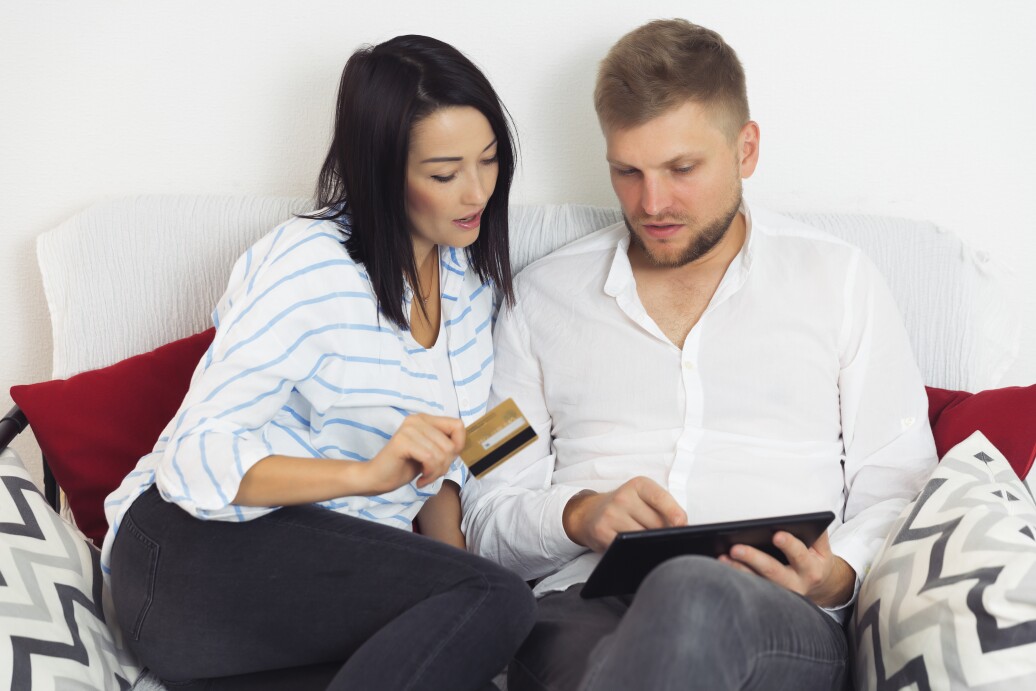 Couple with tablet and credit card browsing internet