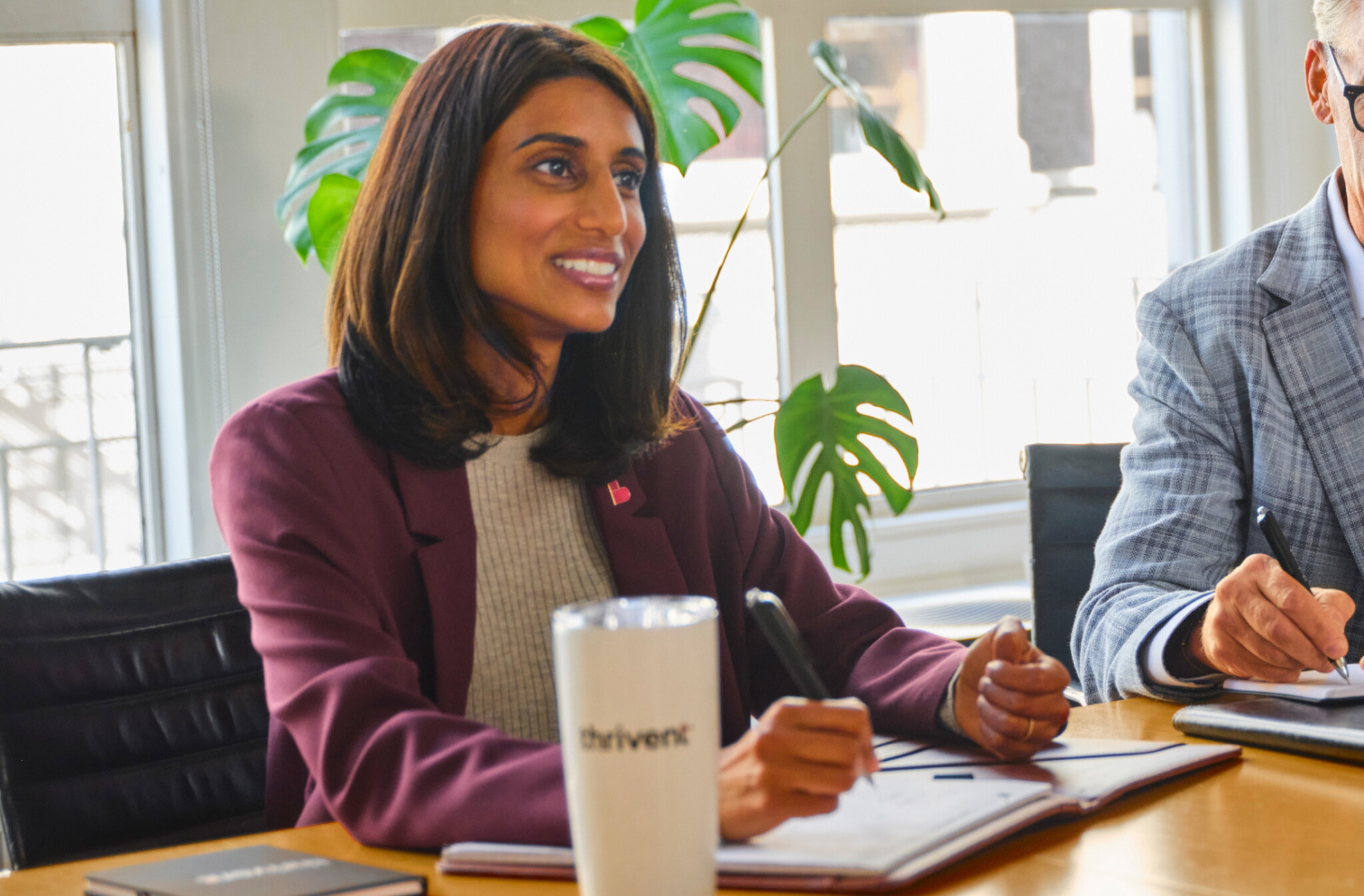 A female Thrivent financial advisor sits at a table