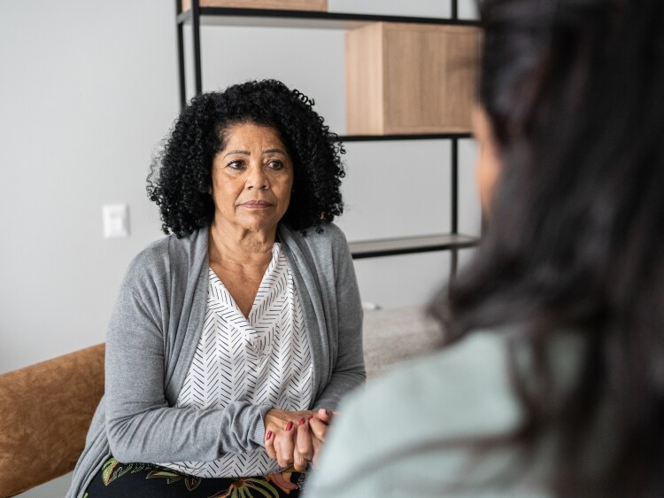 Serious mother listening to daughter.