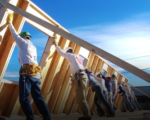 Home framers raise a wall together
