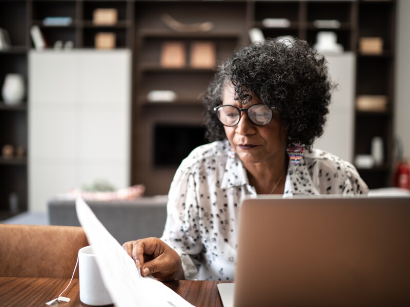 Woman working from home or using laptop planning or paying bills