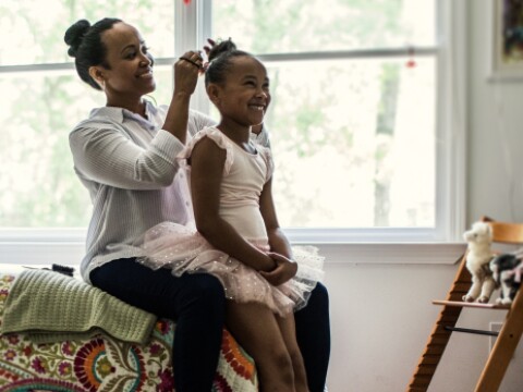Mother doing her daughter's hair