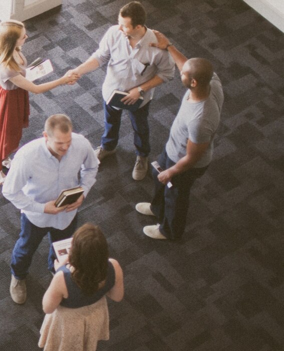 Photo of five people meeting