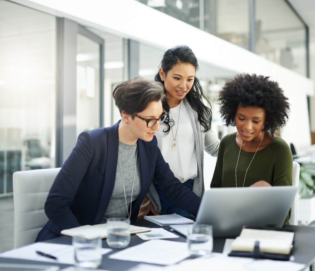 Shot of a group of businesswomen using a laptop during a meeting