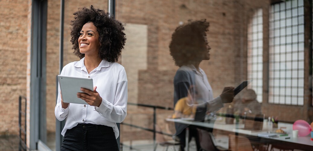 A woman is holding a tablet.