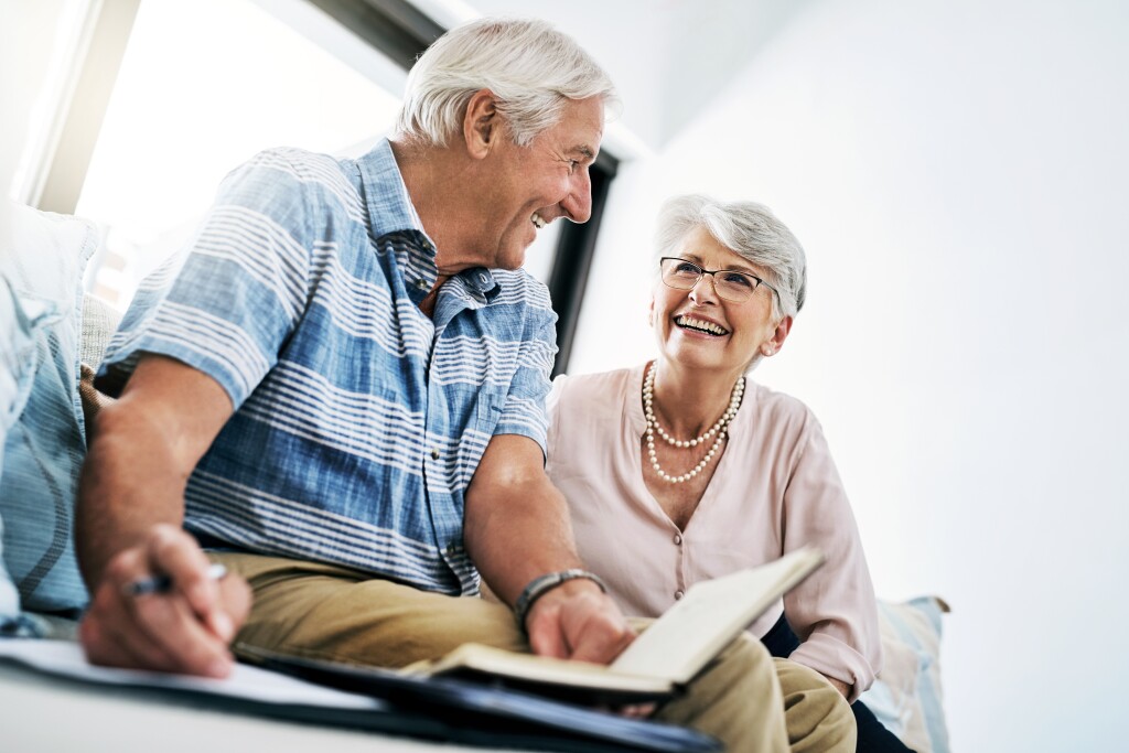 A senior couple going through their paperwork together at home