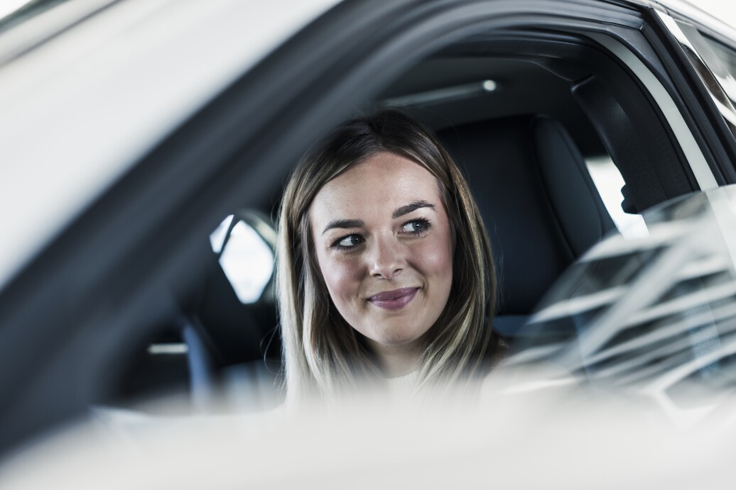Smiling young woman in car