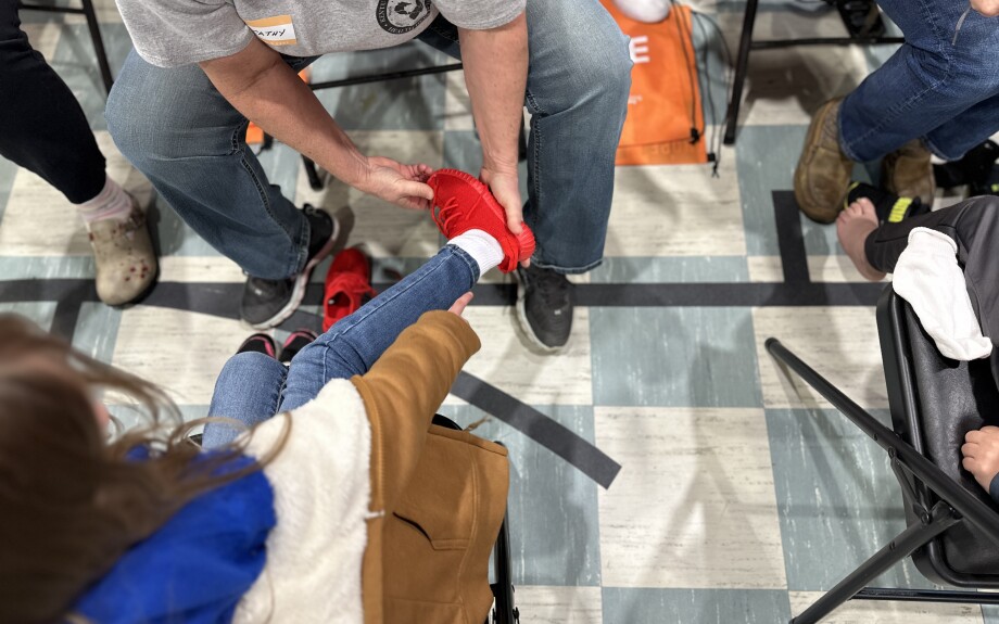 A student receives a new pair of athletic shoes for the school year.