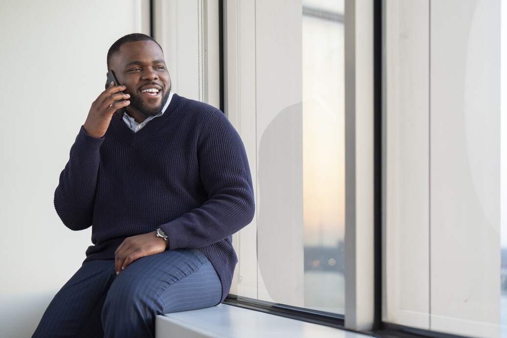 Man on phone looking out the window