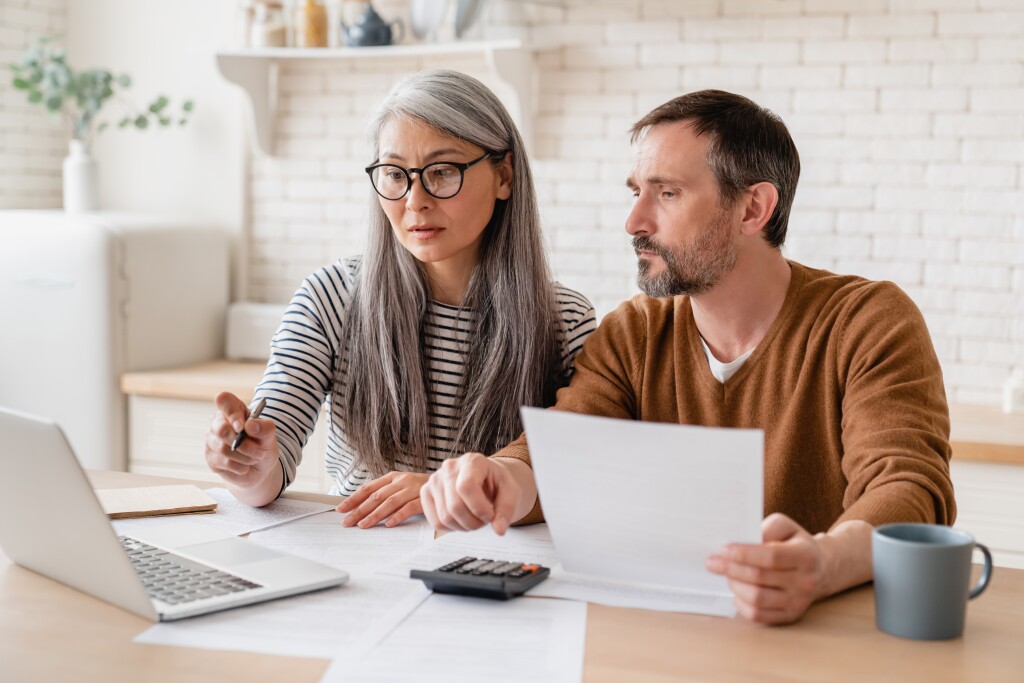 Couple with laptop and calculator