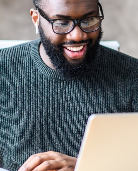 Photo of man using their laptop