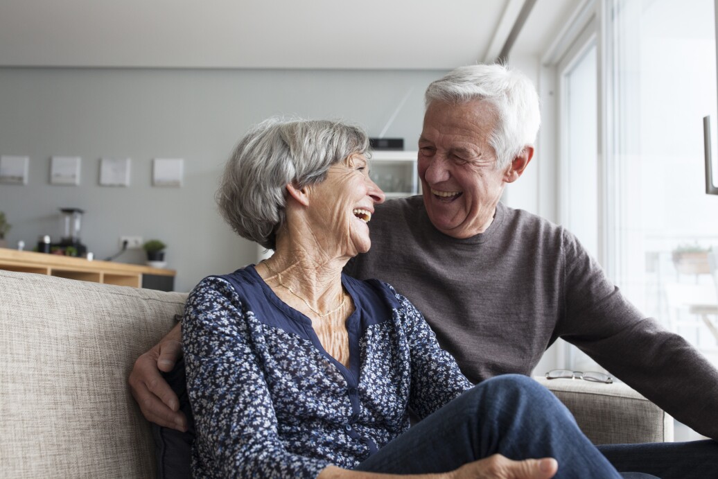 Senior couple looking at each other laughing