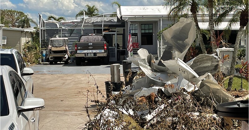 Debris lined the sides of the road in Fort Myers after Hurricane Ian.