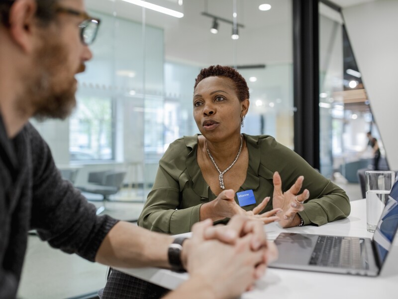 Manager meeting, talking with client in bank branch
