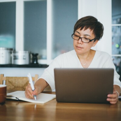Woman working on her home finance with laptop at home
