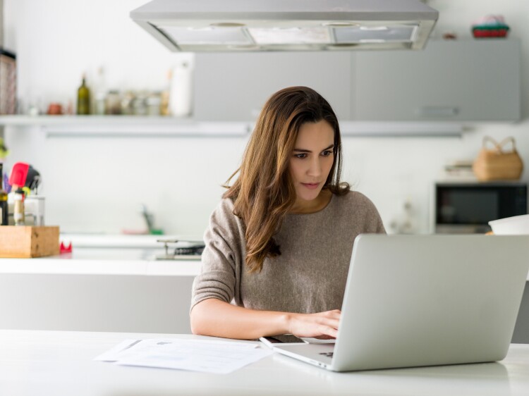 Woman working on her laptop computer at home