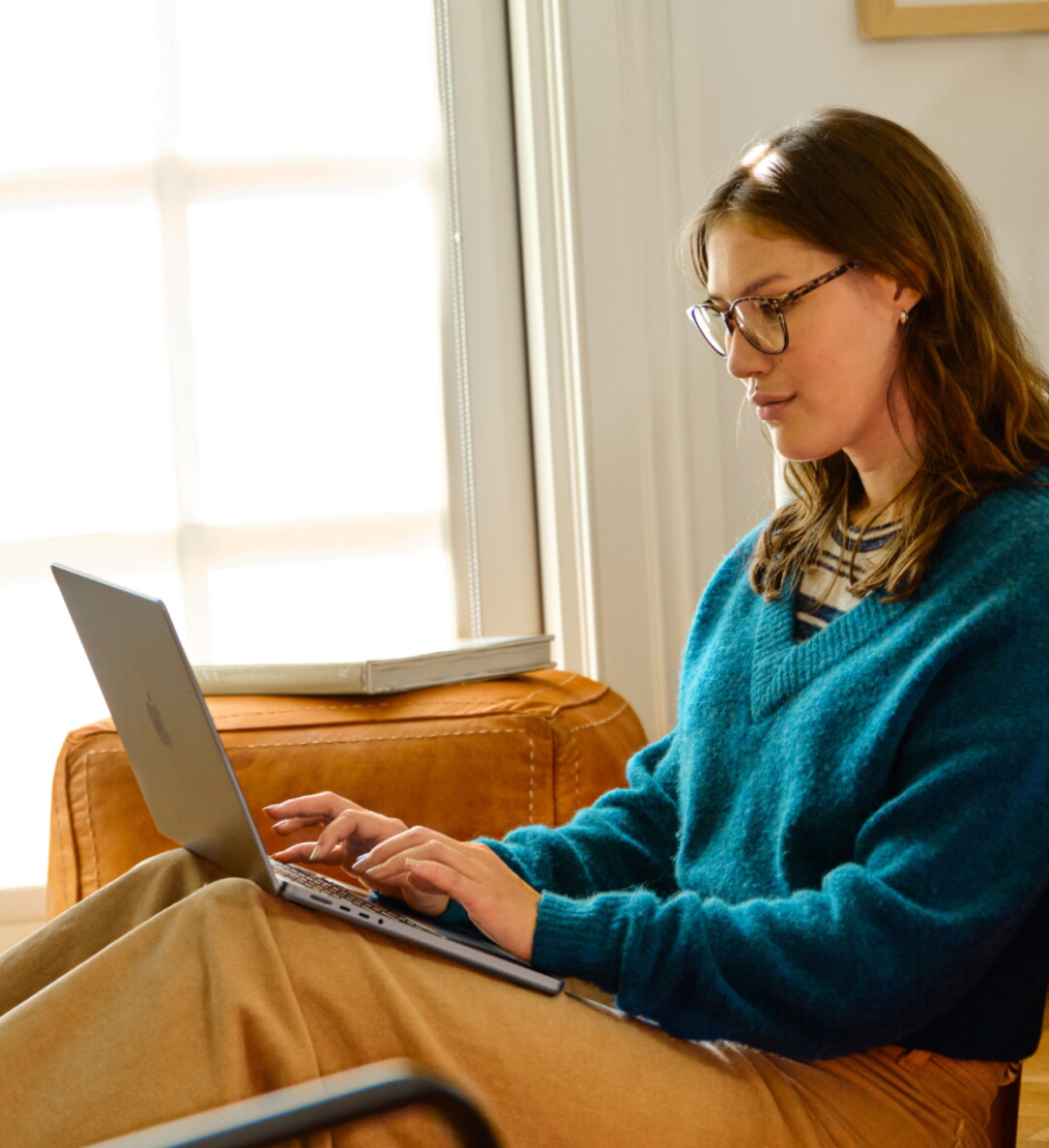 A woman works on her laptop