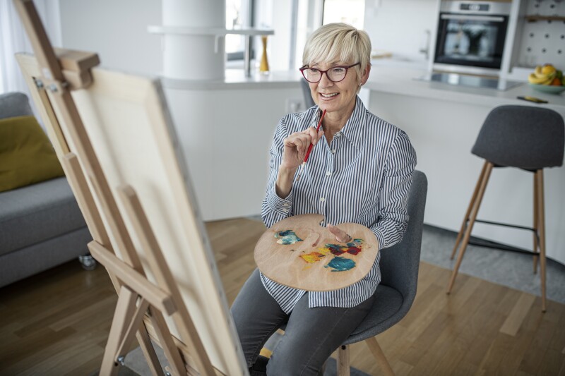 Woman nearing retirement learning new hobby of painting