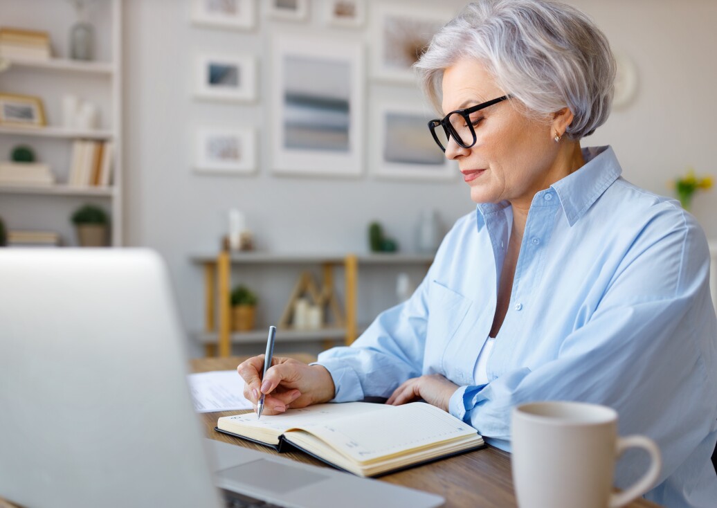 Mature woman taking notes