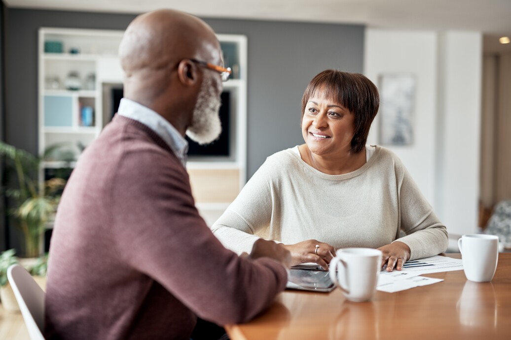 Couple discussing papers over coffee