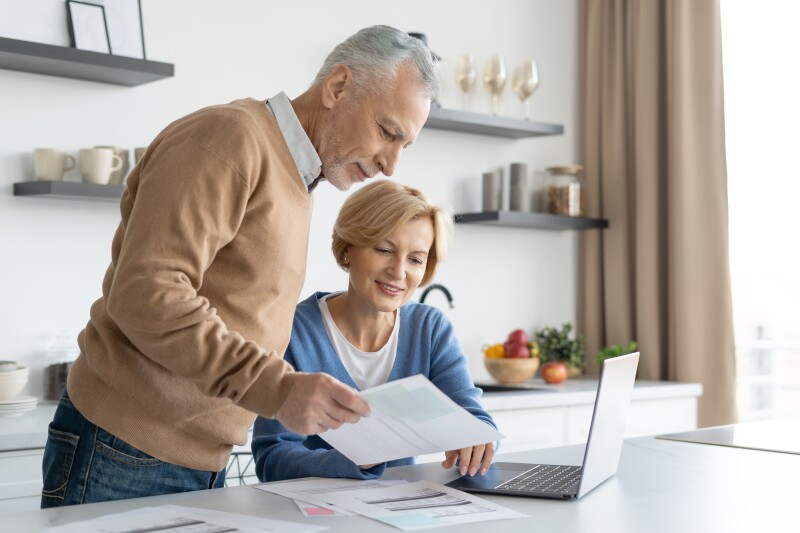 Middle aged couple checking finance account together