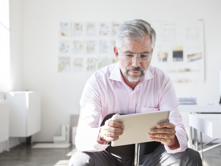 Portrait of businessman using digital tablet in an office
