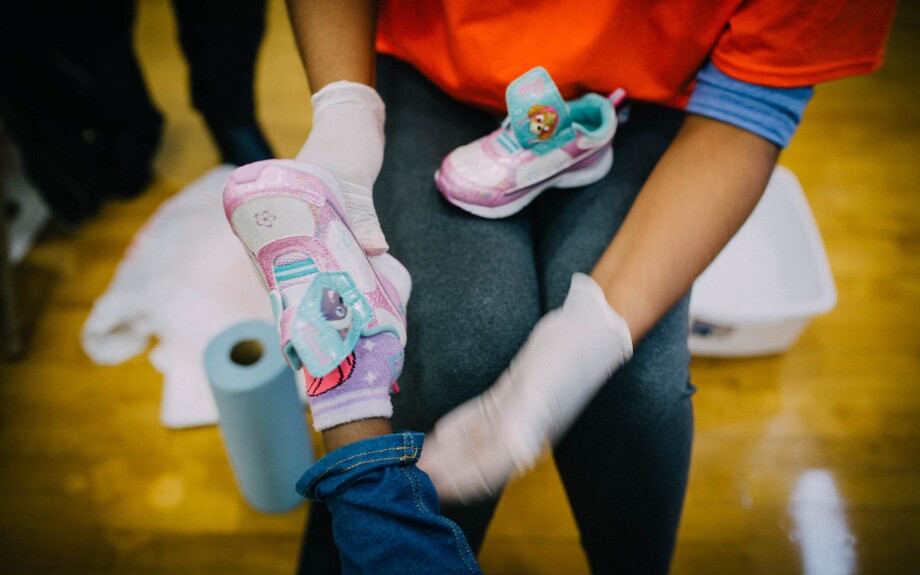 A student receives a new pair of athletic shoes for the school year.