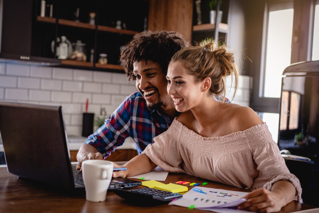 Couple looking at computer smiling