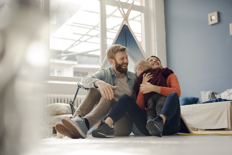 Happy family playing with their son at home