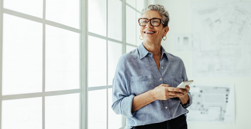 Woman smiling using mobile