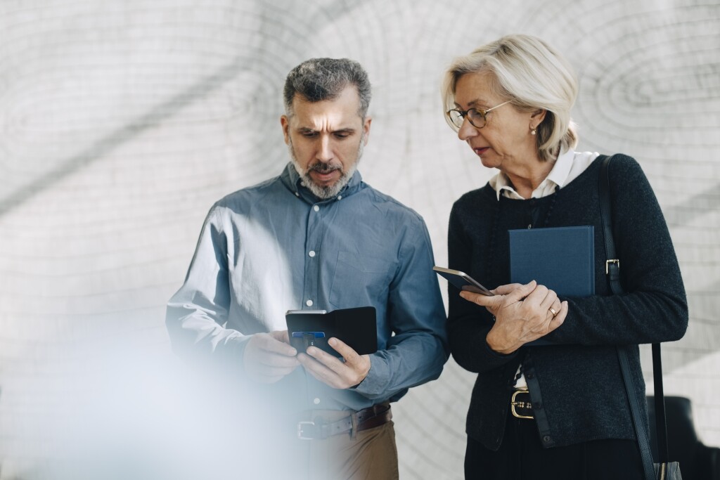 4.15.32 Mature man and woman looking at their phones