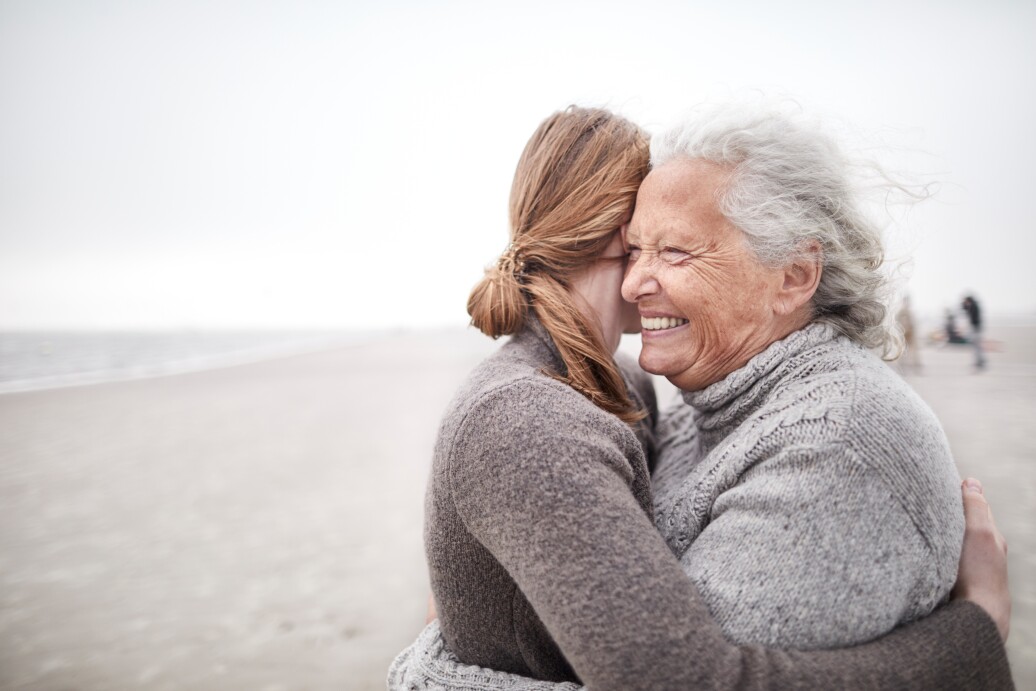 Adult daughter and mother hug
