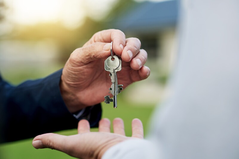 older hand passing keys over to another younger hand