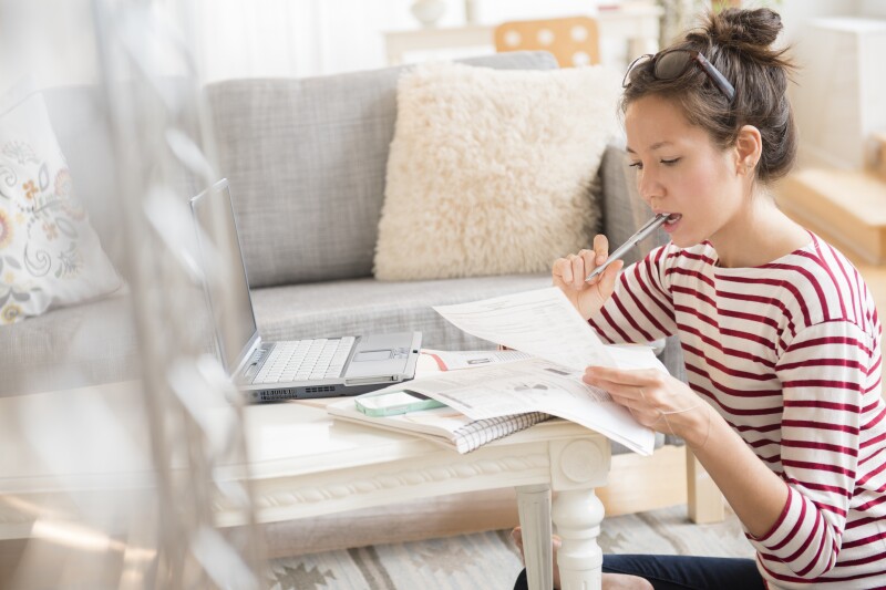 Woman looking at bills