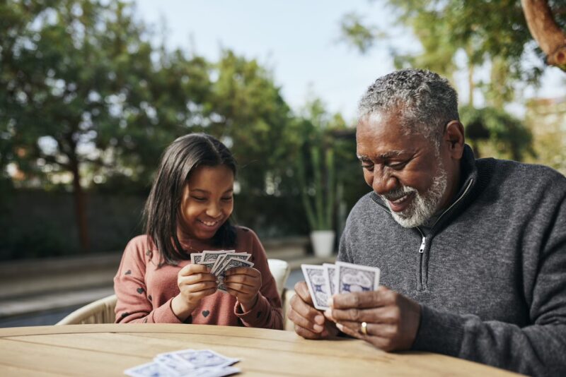 Grandparent and grandchild playing cards