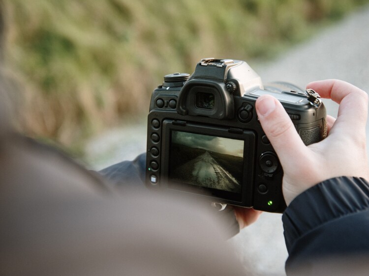 Man taking a picture with a digital camera