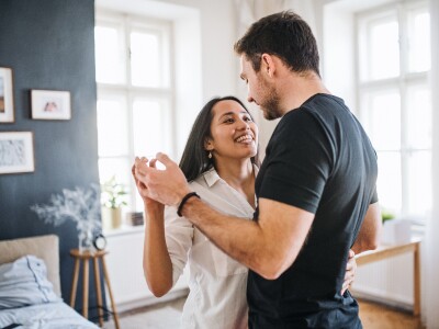 Couple dancing in a bedroom