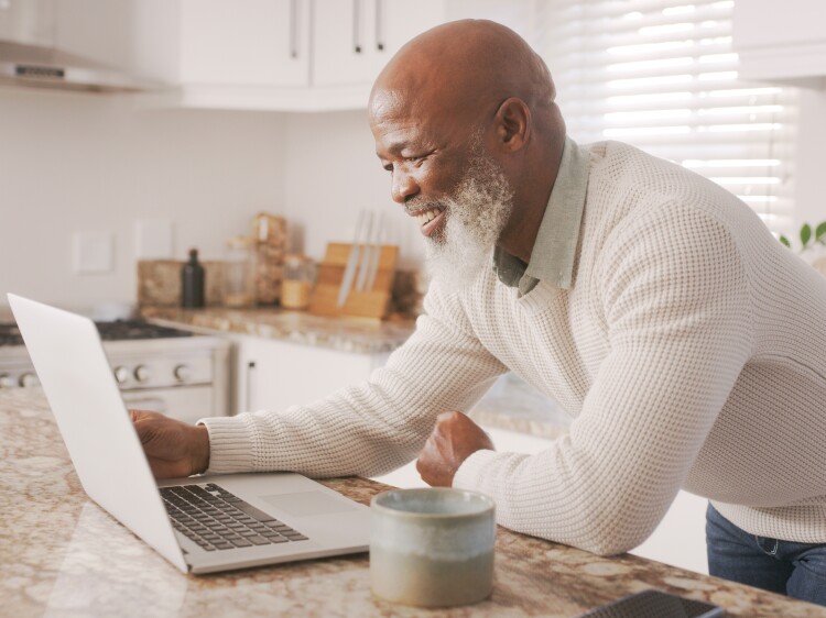 Happy senior guy, computer and working in house