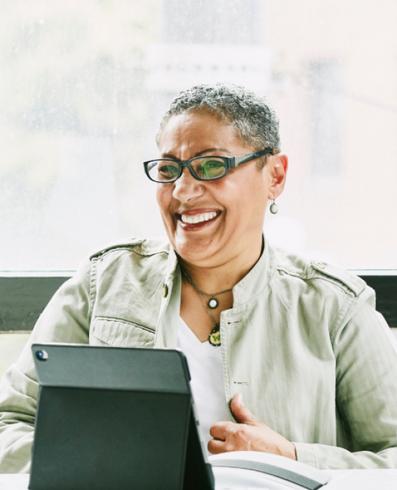 Two women financial advisors smiling at a desk.