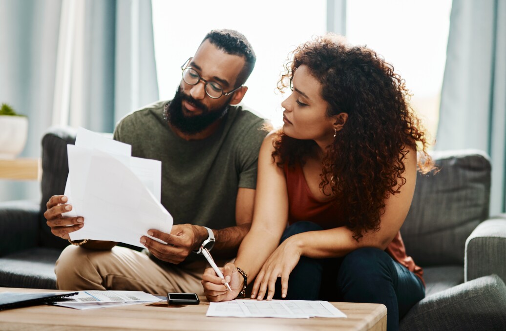 Young couple going over their finances together at home